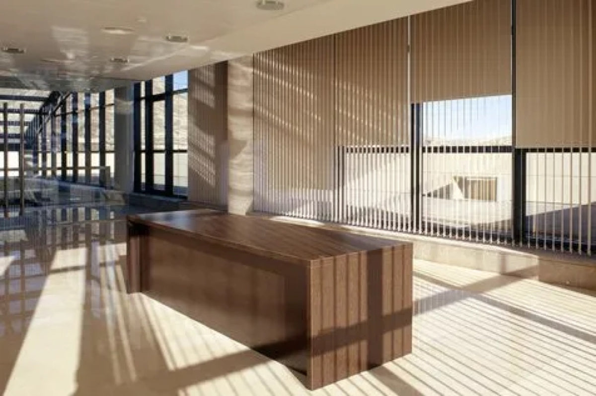Vertical blinds drawn across a wide floor to ceiling window